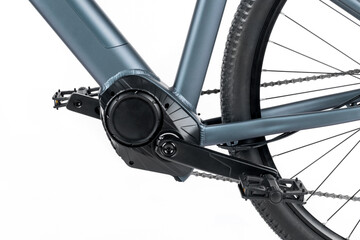 Studio shot of an electric bike's electric motor and pedals in close-up.