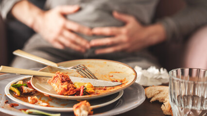 Woman with bloating and stomach pain after eating