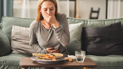 Woman with bloating and stomach pain after eating