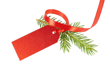 blank red glitter christmas gift tag with ribbon band and fir tree branch isolated on white or...