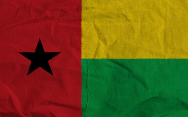 Flag of Guinea-Bissau Depicted on Textured Fabric Background