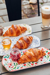 Fragrant croissant breakfast in a cozy old town on the summer terrace of an atmospheric cafe in...