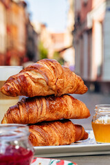 Fragrant croissant breakfast in a cozy old town on the summer terrace of an atmospheric cafe in...
