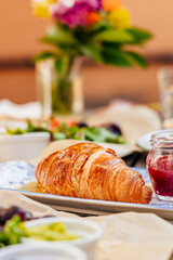 Fragrant croissant breakfast in a cozy old town on the summer terrace of an atmospheric cafe in...