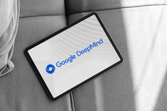 Google deepmind logo displayed on tablet lying on sofa