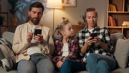 Caucasian family parents mother father using mobile phone smartphones scrolling gadgets addict...