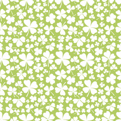 Shamrock or clover leaf flat design green seamless pattern falling leaves on white background vector illustration. Irish holiday celtic St Patrick day motif seamless pattern with shamrock clover leaf.