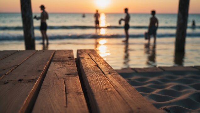 Beautiful brown plank wooden table with blurred background of swimming pool, sea, people and palm tree, sunset sky, blank space for product, copy, and design. - Powered by Adobe