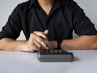 Man holding calculator and pen for business planning or finance calculation