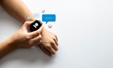 Hand checking smartwatch notifications and messages with digital communication icons on screen