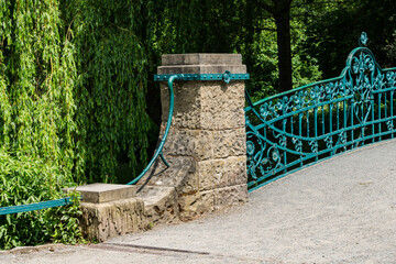 Decorative bridge with unique railing in lush green park setting