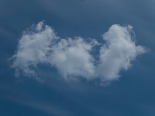 Isolated White Cumulus Cloud Against a Deep Blue Sky