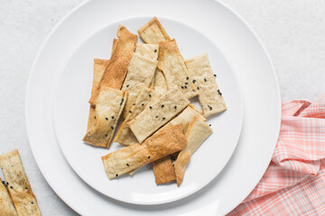 Overhead view of homemade crackers, top view of freshly baked black sesame cracker biscuits, process of making crackers