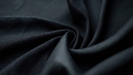 Close-up of black textured fabric showcasing intricate weaving patterns and a gentle sheen, highlighting its tactile nature.