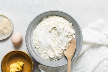 ingredients for making donuts on a marble countertop