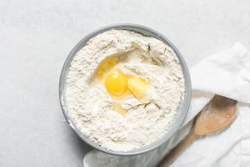 ingredients for making donuts on a marble countertop