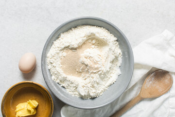 ingredients for making donuts on a marble countertop