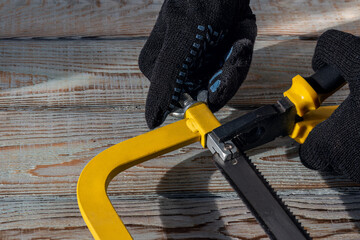 Securing hacksaw with pliers. Working With Hand Saw.