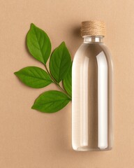 Eco product flat Lay recyclable bottle plastic water A clear glass bottle with a wooden cap beside fresh green leaves on a textured background.