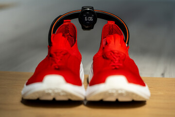 Smart fitness essentials for runners: red sports shoes, GPS smartwatch, and wireless headphones —...