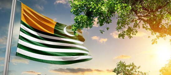 Kashmir national flag waving in the sky behind the tree. The flag blow in beautiful sunlight. 5th...