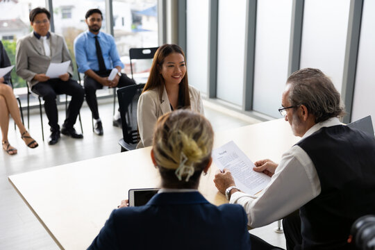 Human resources : company, successful deal. Human resources manager interviewing applicant at modern office.  Asian woman candidate job interviewing and answering question hr CV recruiter