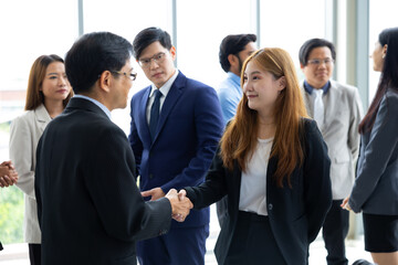 business woman shaking hands on business cooperation agreement. Successful Asian business women handshaking after good deal. successful negotiate, hand shake celebration partnership and business deal