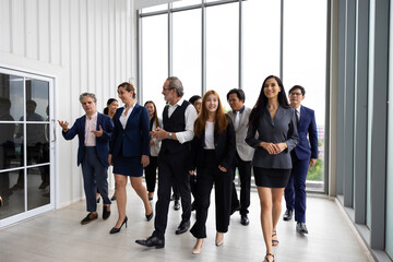 Fototapeta premium group portrait business team walking : Portrait of successful Caucasian business woman leader and business team Multiethnic people standing together at workplace. Diverse team