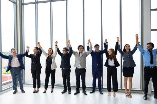 happy business team making high hands up for business teamwork celebrating. business team celebrating success and having fun