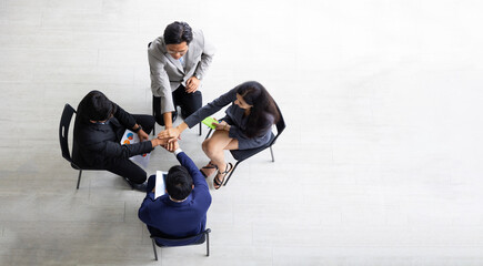 Top view, above team hands together. Unity and teamwork. High angle top view business team showing...