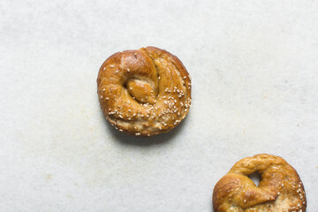 Overhead view of homemade pretzels, top view of freshly made soft pretzels on a white background