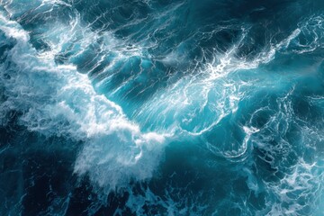 Aerial view of ocean with a cresting wave Swirling water patterns and varying shades of blue