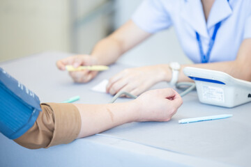Nurse measuring patient blood pressure healthcare medical examination with copy space