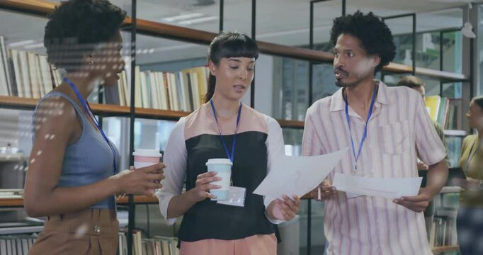Holographic code overlay appearing over team members causing document exchanging and tech reviewing