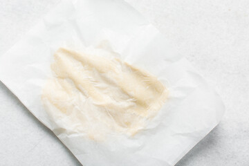Overhead view of cookie dough rolled on parchment paper, Top view of rolled out sugar cookie dough on a white countertop, process of making cut out sugar cookies