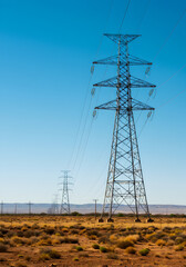 High-voltage electrical tower transmits power across vast distances. The powerful energy infrastructure symbolizes electricity supply, transmission networks, and industrial strength