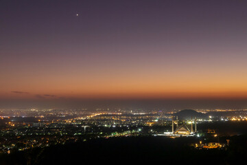 The Faisal Mosque is the national mosque of Pakistan in magic sunset time, located in the capital city, Islamabad. It is the fifth-largest mosque in the world.