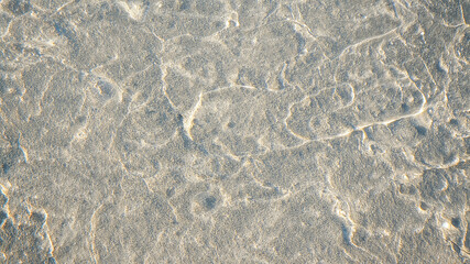 Sunlight reflecting on wet rock surface creating beautiful patterns
