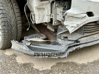 Car is severely damaged following a collision and road accident incident recently. This image features a detailed closeup of a car showing extensive frontend damage resulting from a serious accident