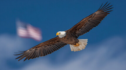 Obraz premium Majestic bald eagle soaring across a clear blue sky, wings spread wide, with the American flag waving in the background. 