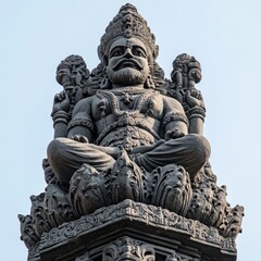 Obraz premium Dark stone statue of seated deity, ornate details