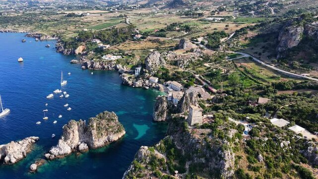 Il mare della Sicilia, Italia. Tonnara di Scopello. 4K
Vista aerea della costa pi&ugrave; bella della Sicilia. La baia di Scopello, tra Palermo e San Vito Lo Capo. Riserva dello Zingaro. 