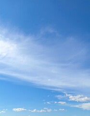Fototapeta premium blue sky with light scattered white clouds