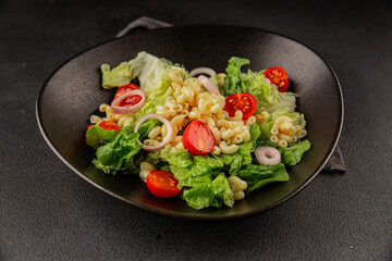 Pasta salad green leaf lettuce, tomato, pasta, onion fresh delicious gourmet food background on the table rustic food top view copy space keto and paleo diet vegan and vegetarian food