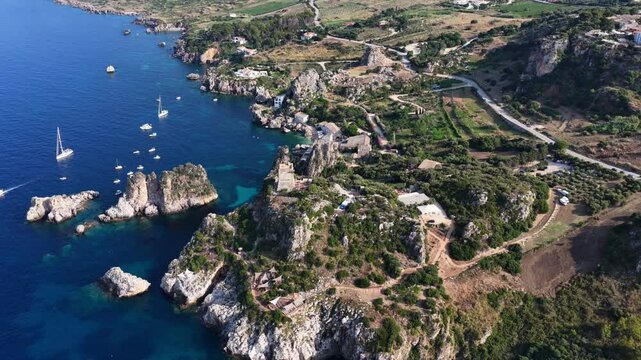 Il mare della Sicilia, Italia. Tonnara di Scopello. 4K
Vista aerea della costa pi&ugrave; bella della Sicilia. La baia di Scopello, tra Palermo e San Vito Lo Capo. Riserva dello Zingaro. 