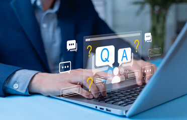 Businessman clicking Q and A or FAQ button on digital platform, representing questions and answers,...
