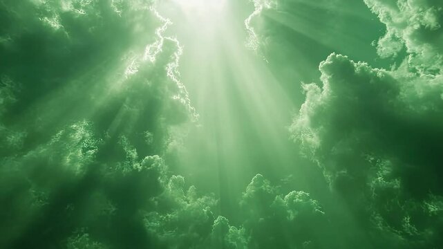 A beam of light shining through dark clouds with a green screen background  