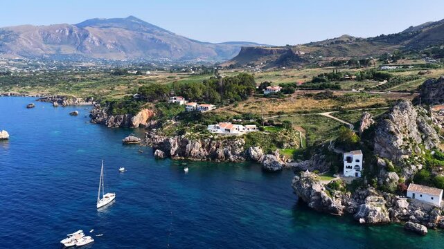 Il mare della Sicilia, Italia. Tonnara di Scopello. 4K
Vista aerea della costa pi&ugrave; bella della Sicilia. La baia di Scopello, tra Palermo e San Vito Lo Capo. Riserva dello Zingaro. 