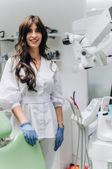 Portrait of a young female dentist in uniform at a modern dental clinic, smiling confidently.