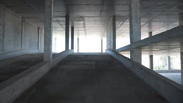 Concrete ramp inside unfinished multi level parking structure